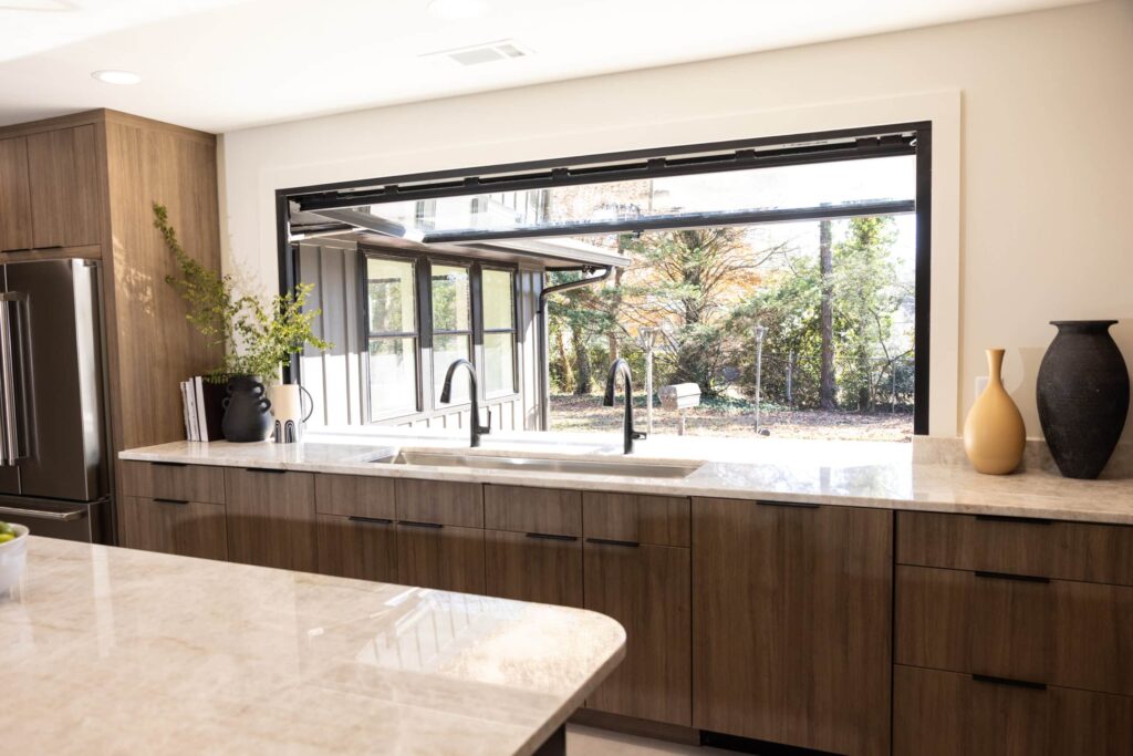 Interior view of a motorized OpenUp® pass-through window opening over a kitchen countertop.