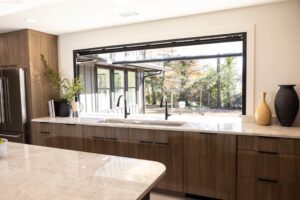 Interior view of a motorized OpenUp® pass-through window opening over a kitchen countertop.