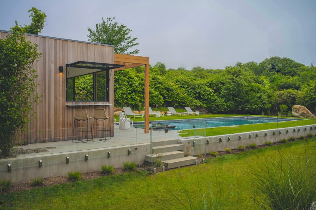 Exterior pass-through window on a modern pool house in the Hamptons.